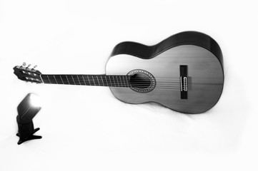Classical guitar illuminated by the light of a professional flash. Black and White photo.
