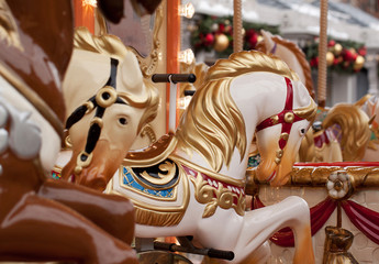 Fototapeta na wymiar beautiful and bright carousel with horses at the festive fair