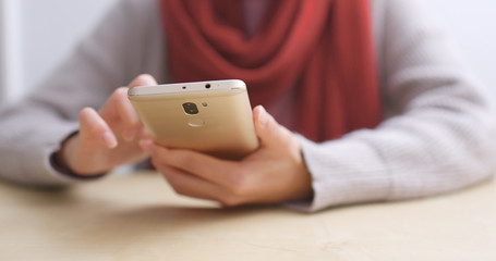 Woman using mobile phone at home