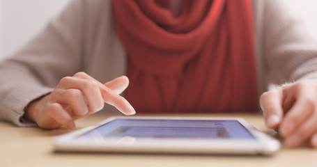 Woman touch on tablet computer on table