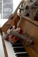 Classical violins on piano keys, guitar and cymbal. Classical musical instruments for music...