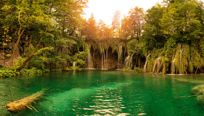 Sunset, Waterfall and an old tree in the green water © Ralf Punkenhofer