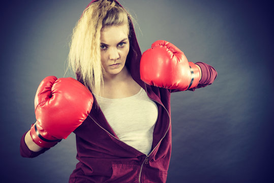 Angry woman wearing boxing gloves