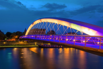 Fototapeta na wymiar Bernatka footbridge over Vistula river in Krakow at night. Poland. Europe.