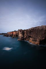 Fototapeta na wymiar Panoramic view of cliff and sea in the Portuguese coastline. Long exposure