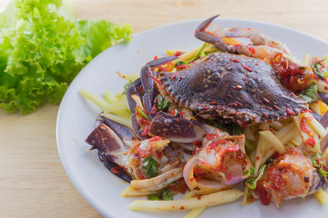 Salted crab in the dish on wooden plate