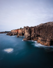 Panoramic view of cliff and sea in the Portuguese coastline. Long exposure