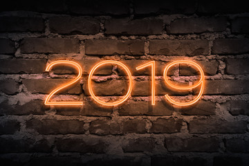 Upcoming 2019 year as neon sign on brickwall pattern as backgound
