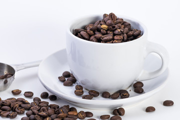 Coffee or espresso cup with coffee beans plain white background
