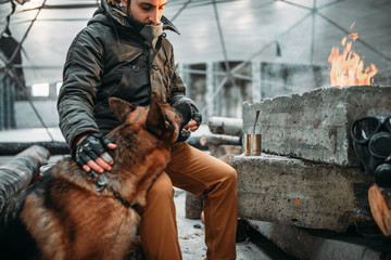 Stalker, post-apocalypse soldier feeding a dog