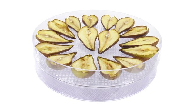 Time-lapse of drying (dehydrating) pear fruit slices 1x2 in 4K format on white background
