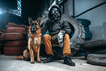 Stalker in gas mask and dog, post-apocalypse
