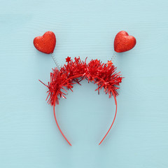 Top view image of funny party head glitter accessory with hearts. Flat lay.