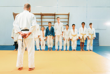 Trainer and little boys, kid judo training