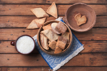 Homemade biscuits and fresh milk on rustic background,