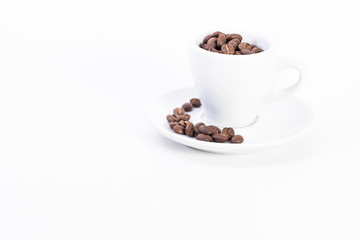 Coffee beans in a coffee or espresso cup next to a heart, Valentine's Day