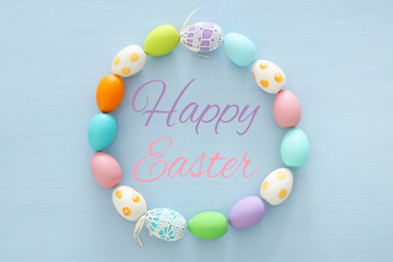 Top view of easter colorful eggs over blue background.