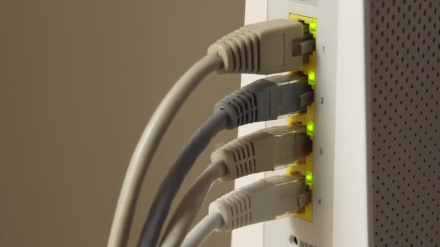 Ethernet cables in a modem with lights flashing.