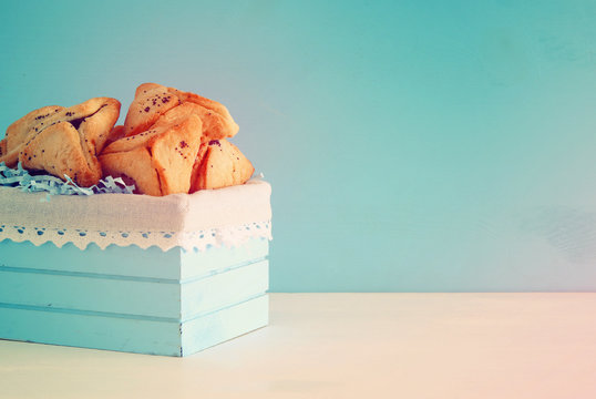 Purim celebration concept (jewish carnival holiday). Traditional hamantaschen cookies over white table.