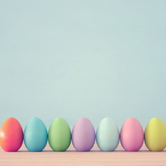 Top view of easter colorful eggs over blue background