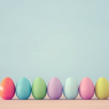 Top View Of Easter Colorful Eggs Over Blue Background