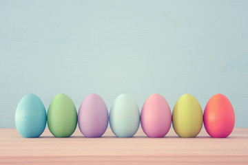 Top view of easter colorful eggs over blue background