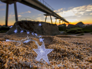 sunrise bridge rocks sea