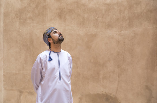 arab man in traditional omani outfit in an old castle