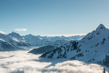 Snow on the top of the mountains and fog down the valley