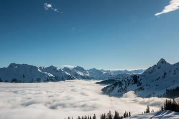 Snow on the top of the mountains and fog down the valley