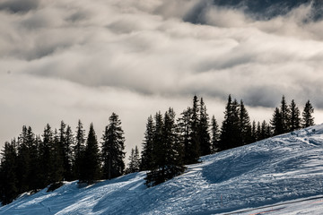 Snow on the top of the mountains and fog down the valley