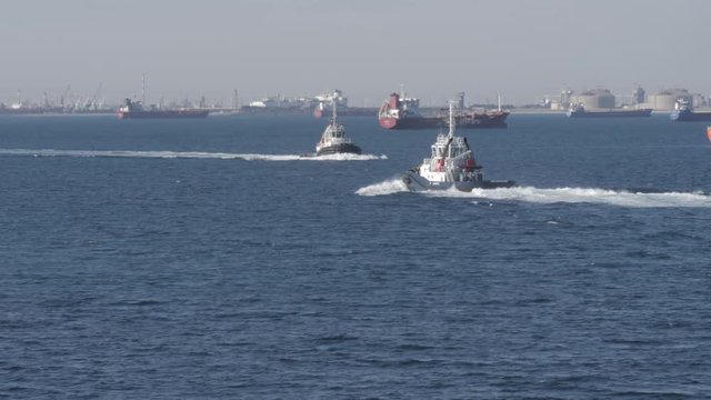 Tug boats sails towards