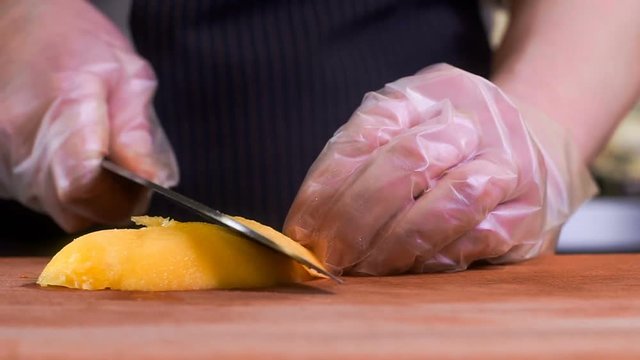 The chef in black apron cuts vegetables. tartar