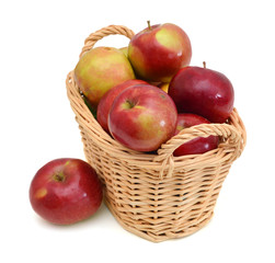 Red apples in basket on white