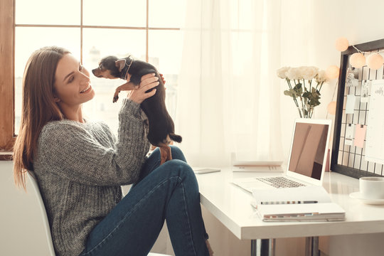 Young Woman Freelancer Indoors Home Office Concept Winter Atmosphere Sitting With Dog