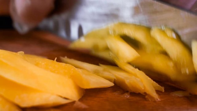 The chef in black apron cuts vegetables. tartar