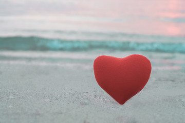 Fototapeta premium Red heart on the beach in sunset