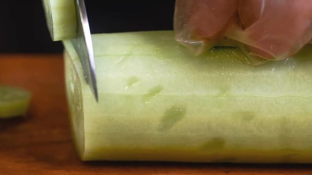 The chef in black apron cuts vegetables. tartar