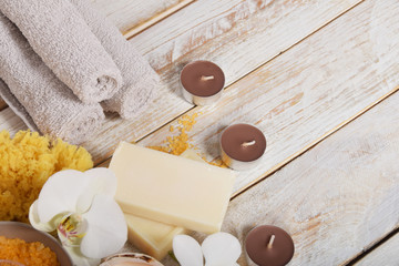 fruit bath salt with olive oil and gray natural soap next to the orchidwith place for text