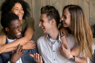 Two happy african and caucasian couples embracing bonding having fun together, young cheerful diverse men and women in love hugging smiling laughing, multiracial friendship, racial diversity concept