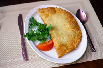 cheburek on a plate top view close-up