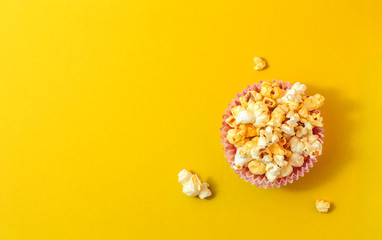 Popcorn on a yellow background. Minimal gallery. Flat lay. Copy space.