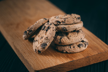 Chocolate chip cookies on dark old wooden table with place for text., freshly baked. Selective Focus with Copy space.