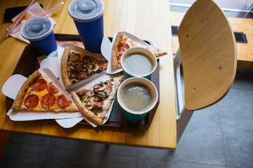 Pizza slices with salami and mushrooms, coffee, drinks.