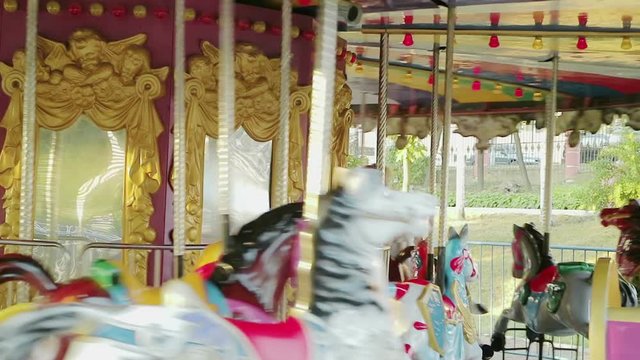 Amusement park. Carousel with horses. Children and adults ride and enjoy
