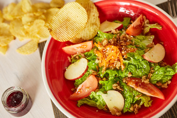 Bright vegetable salad with apple, tomatoes and carrot. Love for a healthy raw food concept. Perfect for the detox diet or just a healthy meal.