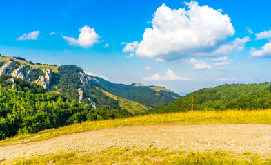 Clouds over the Crimean mountains covered with forest. View from the top of the Demerdzhi mountain in summer. Russia, the Crimea