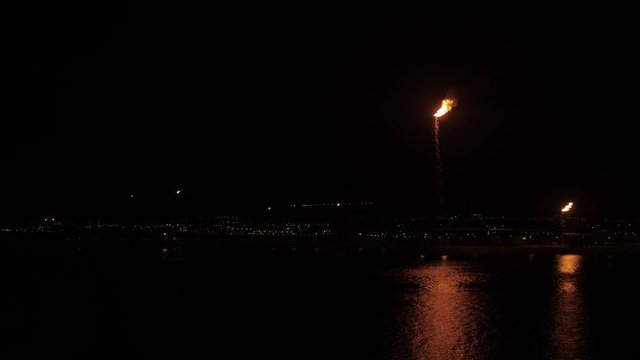 Flare stack of petrochemical refinery in the night