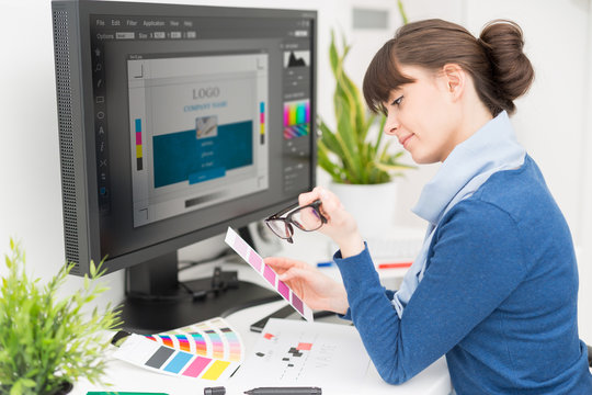 Graphic designer at work. Color samples.