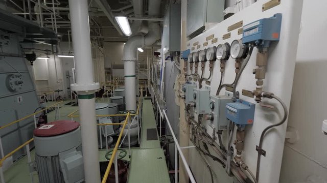 Pumps with electric motors and manometers in engine room of ship